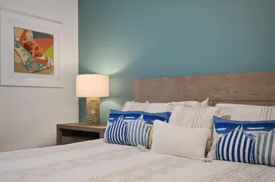 a bedroom with a bed with blue and white pillows at Welcome to the Ultimate Vacation Wonderland in Kissimmee