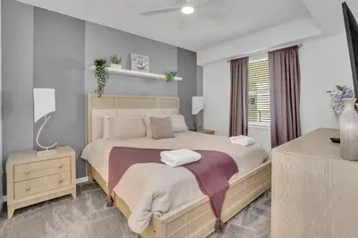 a bedroom with a large bed and a window at Stylish 2-Bed Condo With Resort Amenities/Patio in Kissimmee
