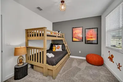 a childs bedroom with a bunk bed and a ladder at Amazing Brand New 5BD, Resort Home/Games Room/Pool in Kissimmee