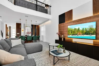 a living room with a couch and a tv at 5BR Family Haven Near Disney with Private Pool in Kissimmee