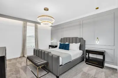 a bedroom with a large bed and a chair at 5BR Family Haven Near Disney with Private Pool in Kissimmee