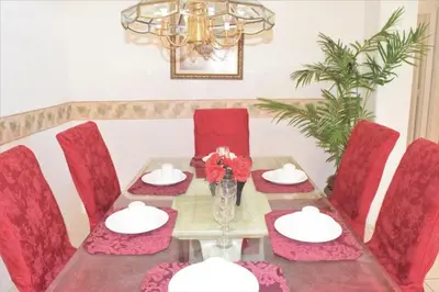a dining room with a table and red chairs at 6 bed property - Indian Creek in Kissimmee
