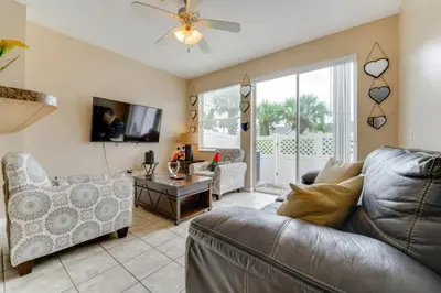 a living room with a couch and a table at 4 Mi to Disney! Family Townhome with Pool Access in Kissimmee