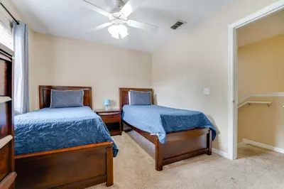 a bedroom with two beds and a ceiling fan at 4 Mi to Disney! Family Townhome with Pool Access in Kissimmee