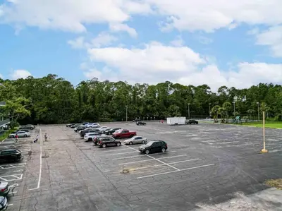 a parking lot with cars parked in it at Lovely 1BR Suite at Orlando with pool view in Kissimmee