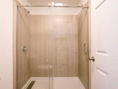 a shower with a glass door in a bathroom at Lovely 1BR Suite at Orlando with pool view in Kissimmee
