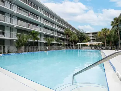 a large swimming pool in front of a building at Relaxing 1BR Pirate themed Condo in Orlando Next to Disney with Pool view in Kissimmee