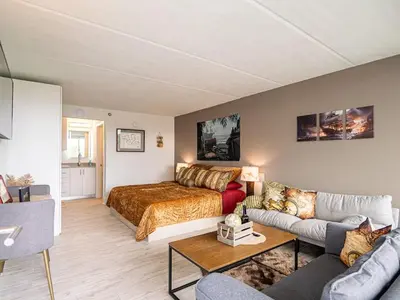 a living room with a bed and a couch at Relaxing 1BR Pirate themed Condo in Orlando Next to Disney with Pool view in Kissimmee