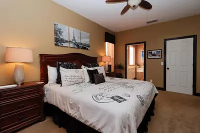 a bedroom with a bed and a ceiling fan at Spacious Emerald Island Resort Home with Pool Spa and Resort Amenities near Disney in Kissimmee
