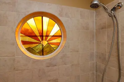 a shower with a stained glass window in a bathroom at Spacious Emerald Island Resort Home with Pool Spa and Resort Amenities near Disney in Kissimmee