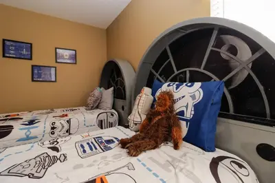 a bedroom with a bed with a star wars bedspread at Spacious Emerald Island Resort Home with Pool Spa and Resort Amenities near Disney in Kissimmee