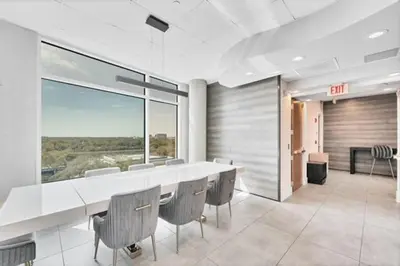 a dining room with a large white table and chairs at Lake Eola Thornton Park Modern 2Bed 2Bath Secure Parking in Orlando