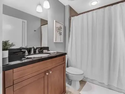 a bathroom with a sink and a toilet and a shower at Lake Eola Thornton Park Modern 2Bed 2Bath Secure Parking in Orlando