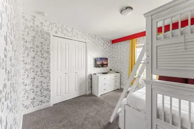 a bedroom with a white bunk bed and a ladder at 5BR 10 minutes from Disney Springs SL4800 in Kissimmee