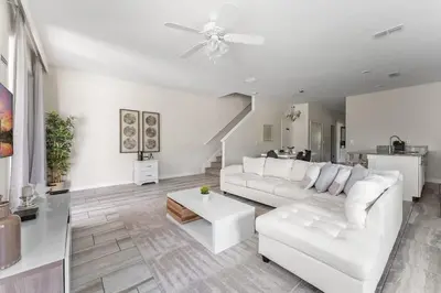 a white living room with a white couch and a table at 5BR 10 minutes from Disney Springs SL4800 in Kissimmee