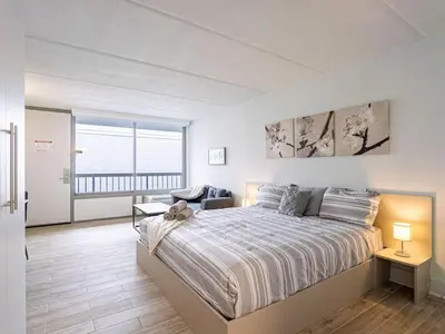 a bedroom with a large bed and a balcony at Chilling 1BR Home in Orlando Next to Disney in Vineland
