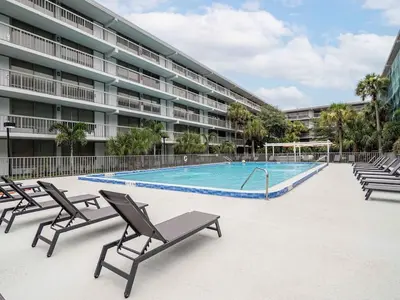 a swimming pool in front of a large building at Chilling 1BR Home in Orlando Next to Disney in Vineland