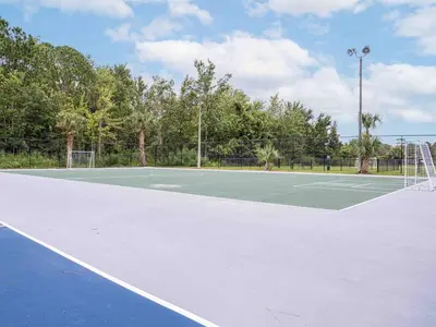 a tennis court with a net on it at Charming 1BR Home in Orlando minutes to Disney in Kissimmee