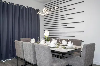 a dining room with a table and chairs at 8761 ZD - Elegant 3BR Villa in The Hub Resort - Comfort, Style, and Luxury for Your Perfect Getaway in Kissimmee