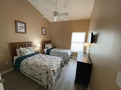 a bedroom with two beds and a ceiling fan at 2029 Morning in Orlando