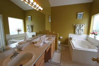 a bathroom with two sinks and a tub and a large mirror at 2029 Morning in Orlando