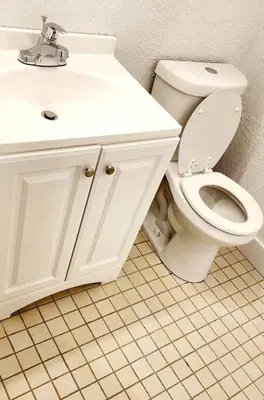 a bathroom with a white toilet and a sink at Ava Lea's Falls in Orlando