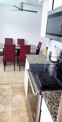 a kitchen with a table with chairs and a counter top at Ava Lea's Falls in Orlando