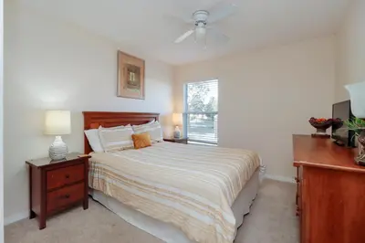 a bedroom with a bed and a ceiling fan at Beautiful Emerald Island Resort Retreat with Private Pool and Spa Close to Disney in Kissimmee