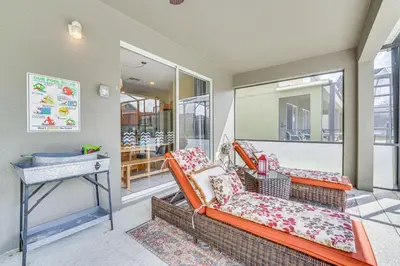 a living room with two chairs and a table at 5 Mi to Disney Ideal Family Getaway with Theater! in Kissimmee