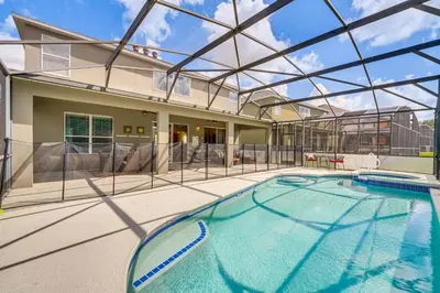a swimming pool in a house with a glass ceiling at 5 Mi to Disney Ideal Family Getaway with Theater! in Kissimmee