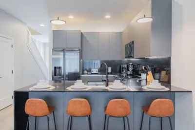 a kitchen with orange chairs and a counter top at TR17145BD - 3 bedrooms home close to Disney in Orlando