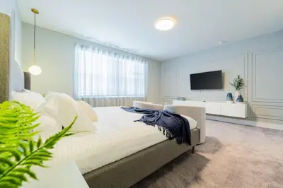 a bedroom with a large bed and a television at TR17145BD - 3 bedrooms home close to Disney in Orlando
