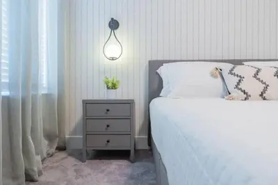 a bedroom with a white bed and a nightstand with a lamp at TR17145BD - 3 bedrooms home close to Disney in Orlando