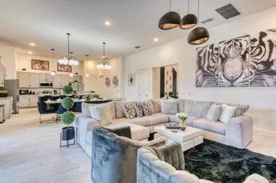 a large living room with couches and a kitchen at Experience Luxury in Your 11 En-Suites Mansion in Orlando