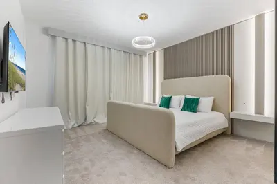 a bedroom with a bed and a large window at Brand NEW 10Bedrooms At Paradiso Grande in Orlando