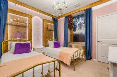 a bedroom with two beds and a chandelier at Brand NEW 10Bedrooms At Paradiso Grande in Orlando