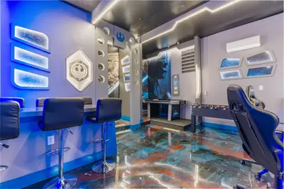 a barber shop with blue walls and floors and chairs at Brand NEW 10Bedrooms At Paradiso Grande in Orlando
