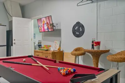 a room with a pool table with bats on it at Single-Level Home w Heated Pool & 9MI to Disney in Orlando