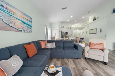a living room with a blue couch and a chair at Single-Level Home w Heated Pool & 9MI to Disney in Orlando