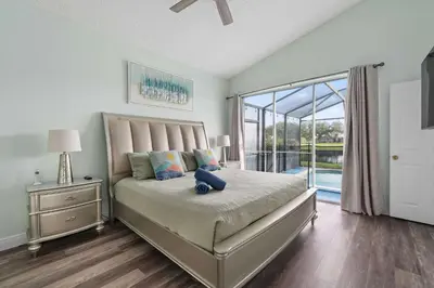 a bedroom with a bed and a large window at Single-Level Home w Heated Pool & 9MI to Disney in Orlando