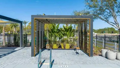 a wooden arch with a fence in a park at Tranquil Trail Bungalow in Kissimmee