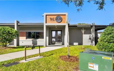 a building with a sign that reads thewrap at Tranquil Trail Bungalow in Kissimmee