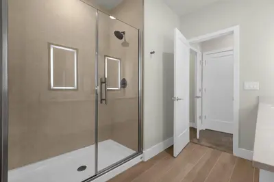 a shower with a glass door in a bathroom at Upstay - Modern Family Townhome with Pool in Orlando