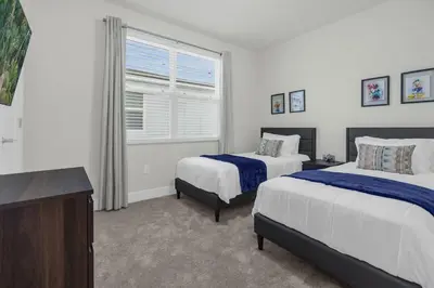 a bedroom with two beds and a window at Upstay - Modern Family Townhome with Pool in Orlando
