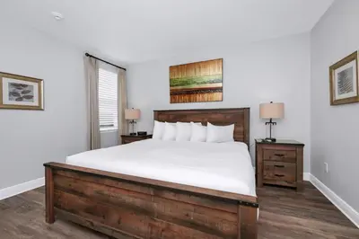 a bedroom with a large bed with white sheets at Grand Home Near Disney With Private Pool And Waterpark & Resort Access At Encore Resorts Reunion - 7519Mr in Kissimmee