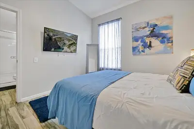 a white bedroom with a bed and a window at Making Memories Resort -Windsor Palms Villa in Kissimmee