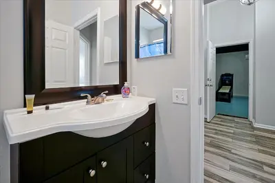 a bathroom with a sink and a mirror at Making Memories Resort -Windsor Palms Villa in Kissimmee