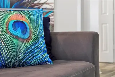 a colorful pillow sitting on top of a couch at Making Memories Resort -Windsor Palms Villa in Kissimmee