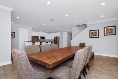 a dining room with a wooden table and chairs at Glorious Home Near Disney With Game Room, Themed Rooms, Waterpark & Resort Access At Encore Resorts Reunion - 7643Wi in Kissimmee