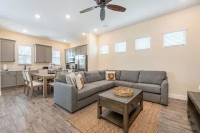 a living room with a couch and a table at Blue Cottage Near Disney With Margaritaville Resort & Island H2O Access - 8067Kd in Orlando